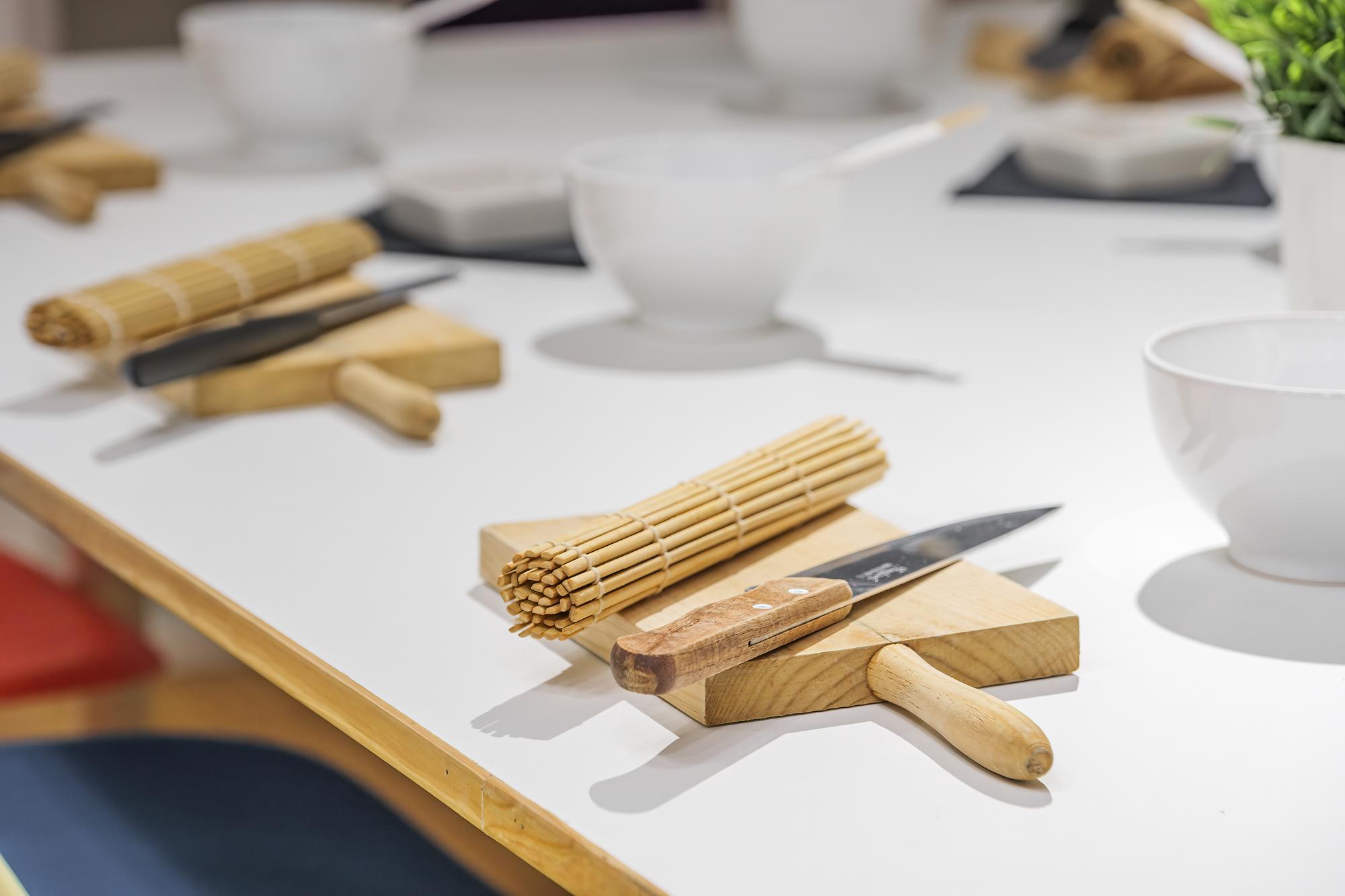 Interior of teaching kitchen with wooden table and utensils